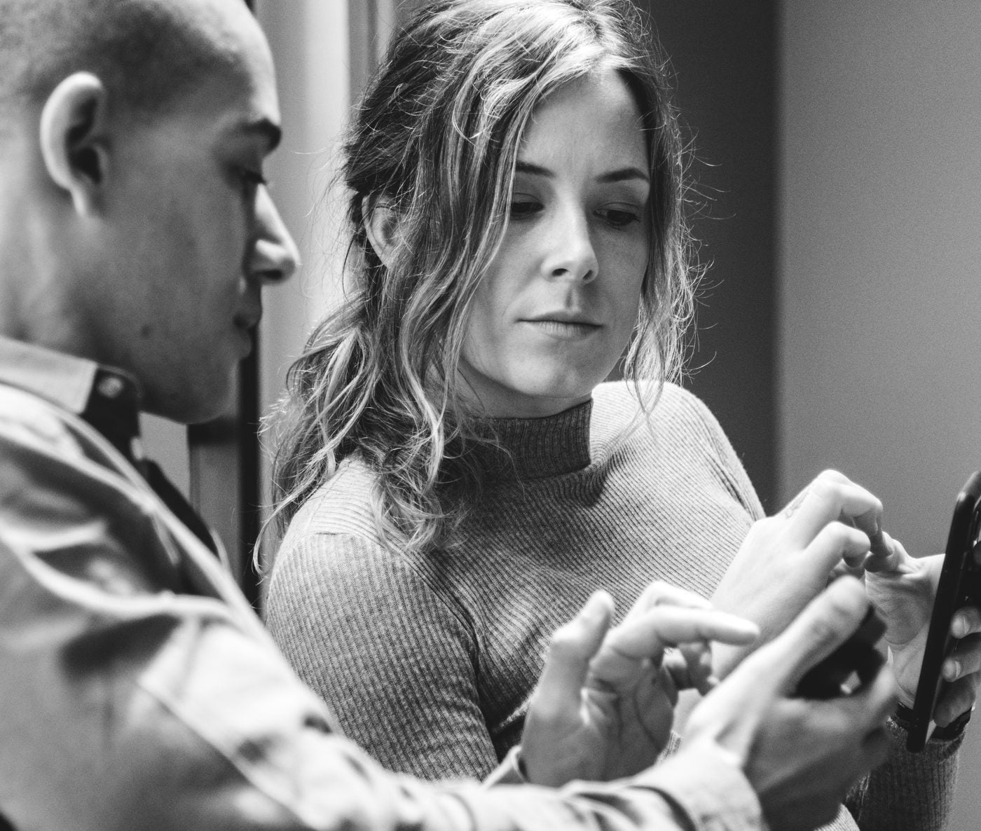 Two people checking whether a link is safe on a phone
